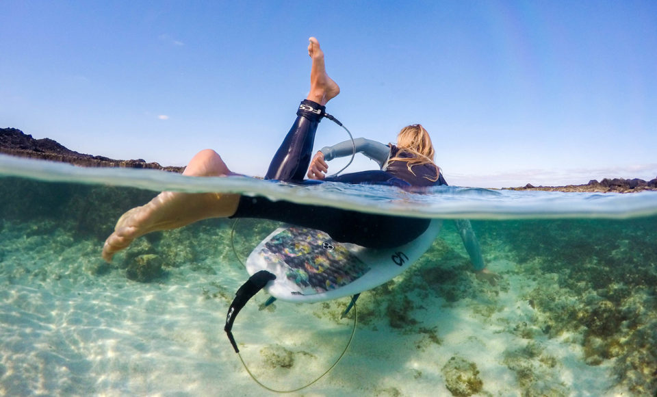 Girl paddling out to surf half half photo
